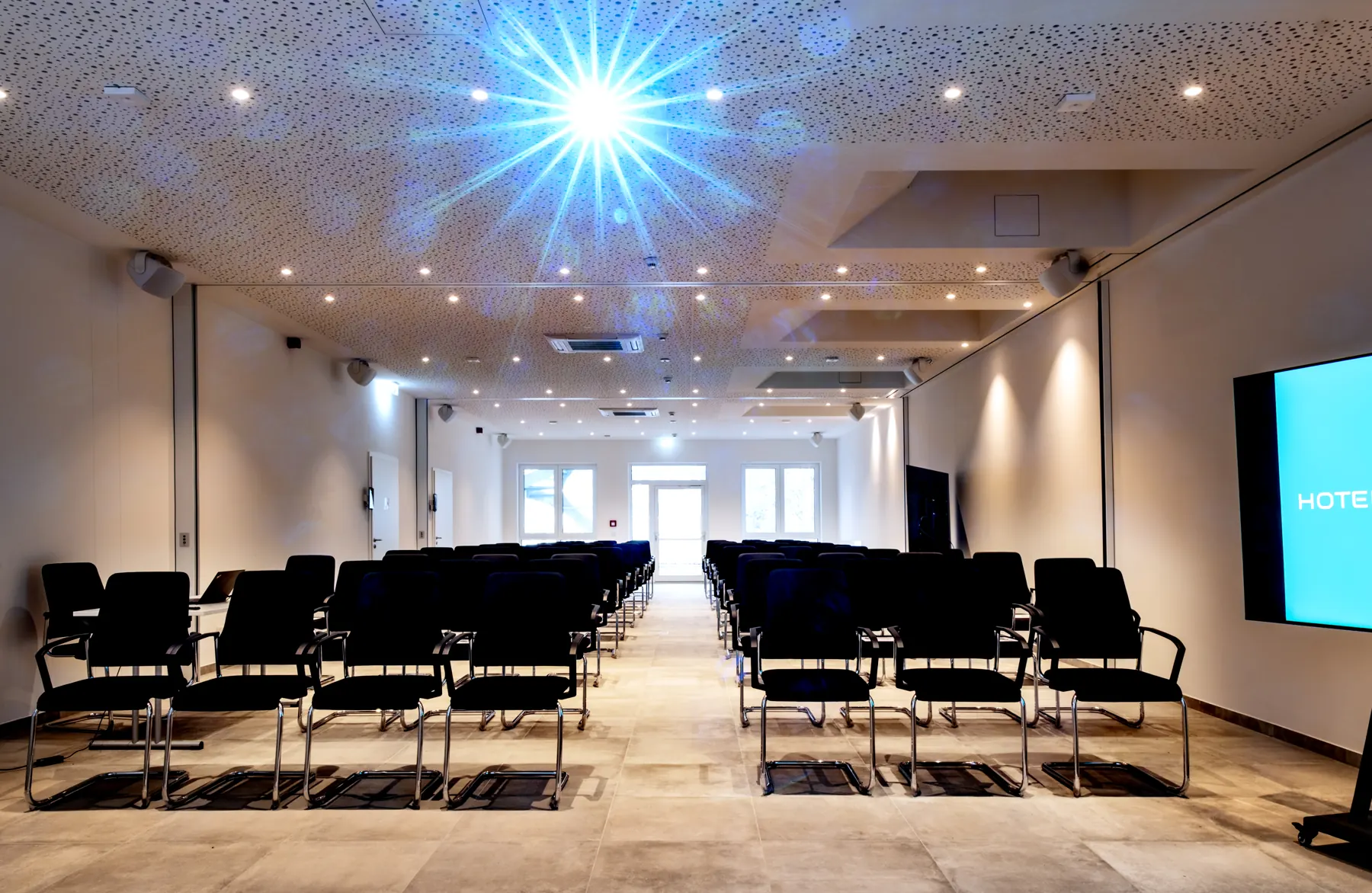 Hall with rows of chairs and screen