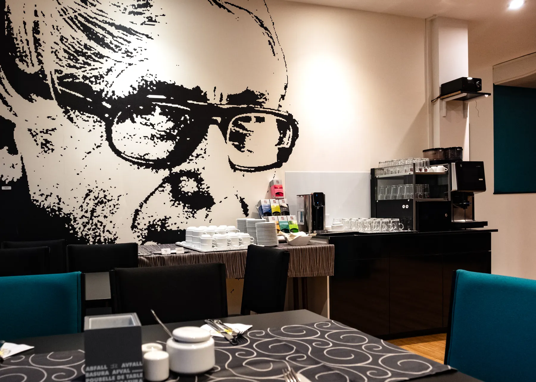 Black-and-white portrait mural in the hotel's breakfast room